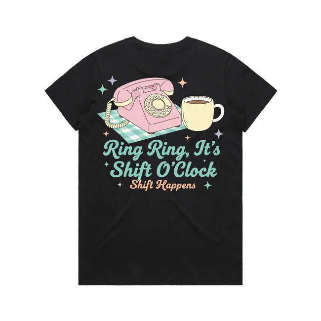 Black t-shirt with a pink phone and coffee cup graphic and text 'Ring Ring, It's Shift O'Clock Shift Happens' on a white background.